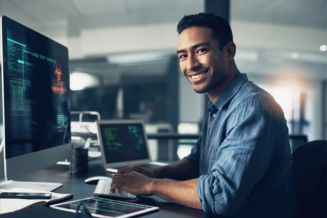 a man sitting at a desk with a computer